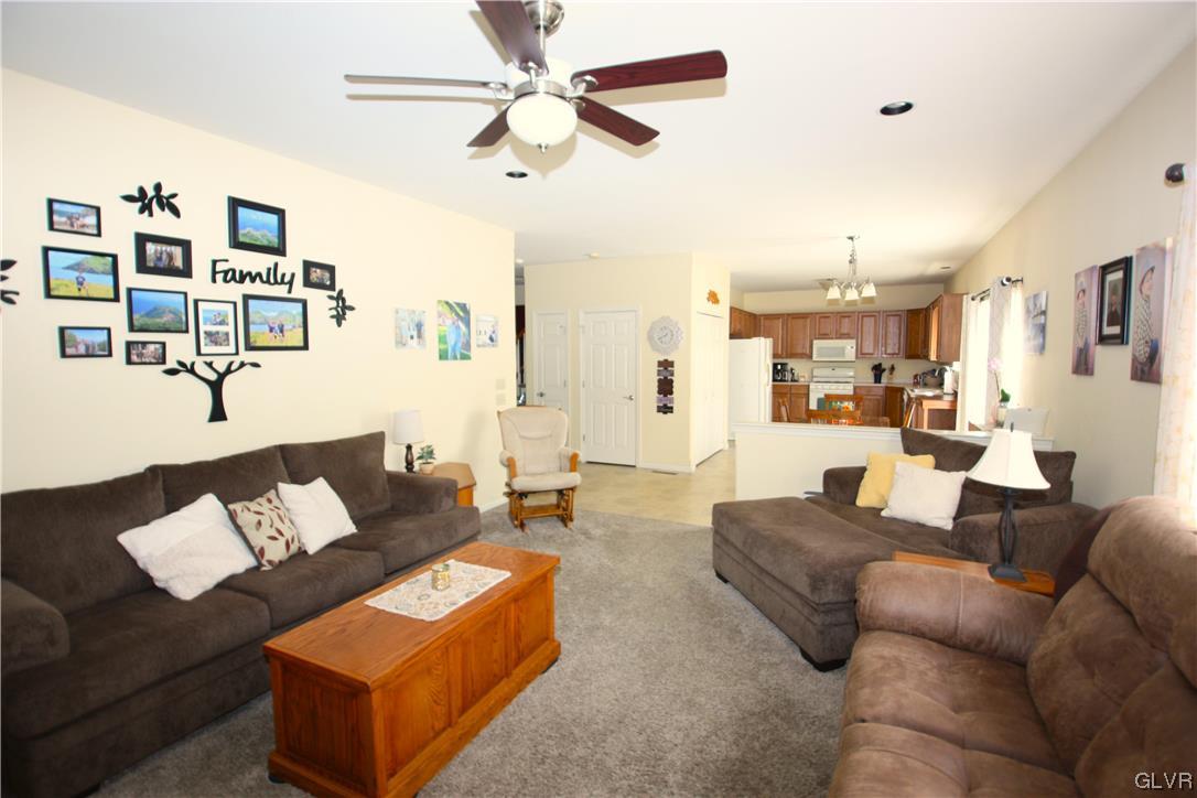 3838 Rittenhouse Road Lower Macungie Township, PA 18062 - Photo 6 of 26 a living room with furniture kitchen view and a chandelier