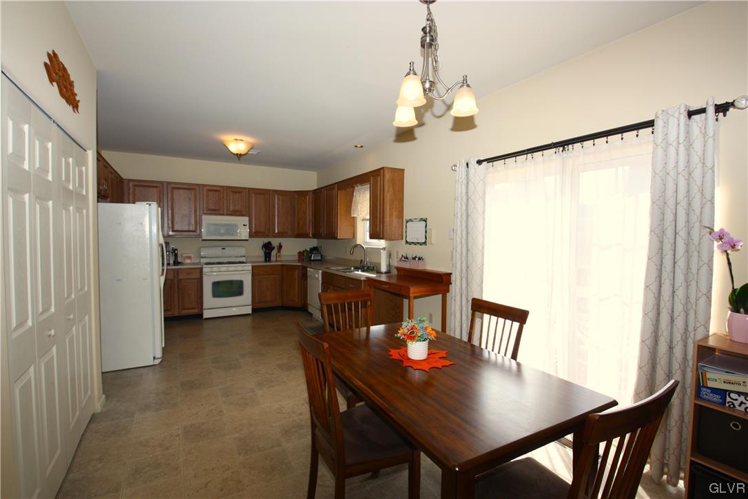 3838 Rittenhouse Road Lower Macungie Township, PA 18062 - Photo 7 of 26 a view of a dining room with furniture and a chandelier