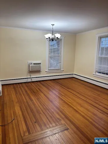 a view of a room with wooden floor