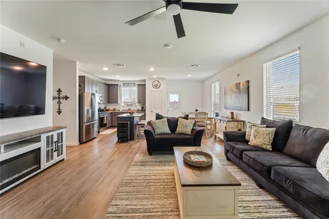 a kitchen with stainless steel appliances granite countertop a refrigerator stove microwave and chair