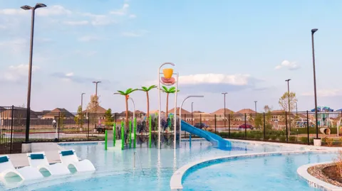 a view of a swimming pool with outdoor seating