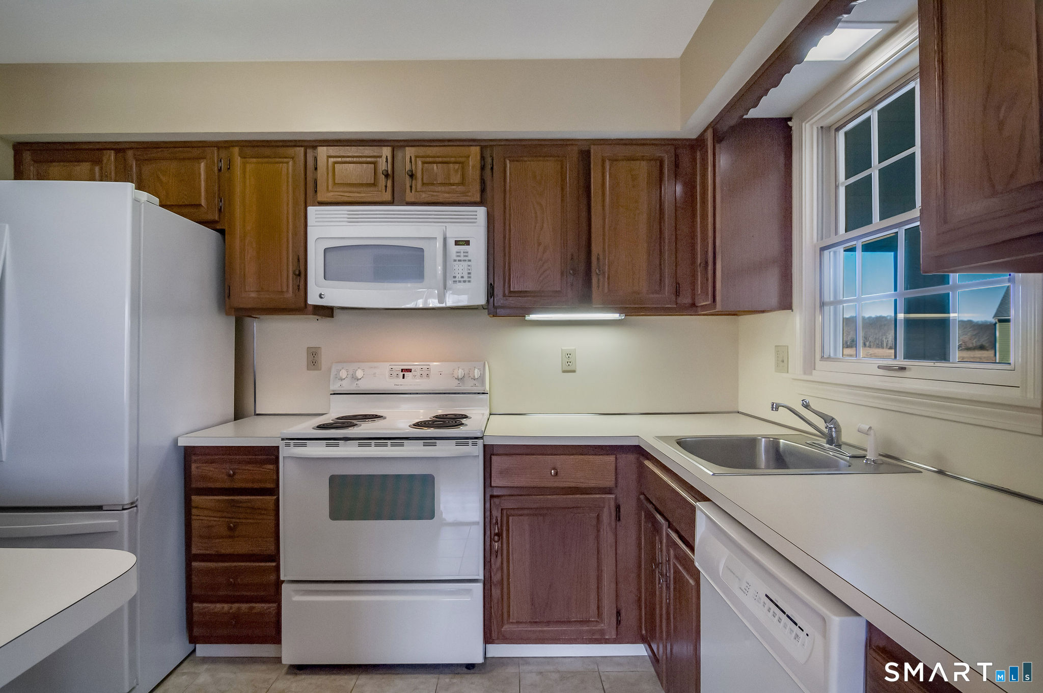 1 Downing Way, Unit 1 Madison, CT 06443 - Photo 11 of 26 a kitchen with a stove sink and cabinets