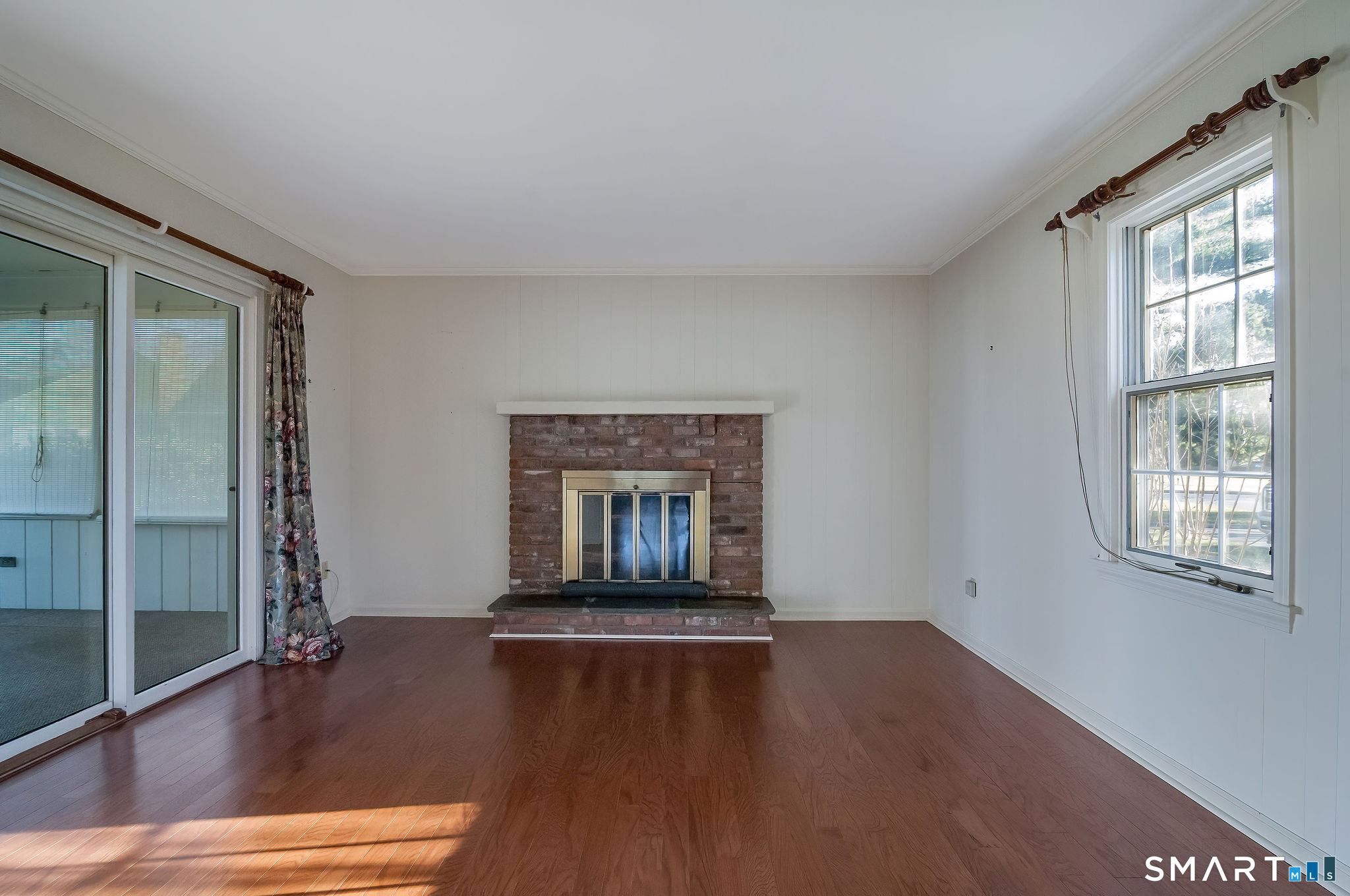 1 Downing Way, Unit 1 Madison, CT 06443 - Photo 14 of 26 a living room with a fireplace and wooden floor