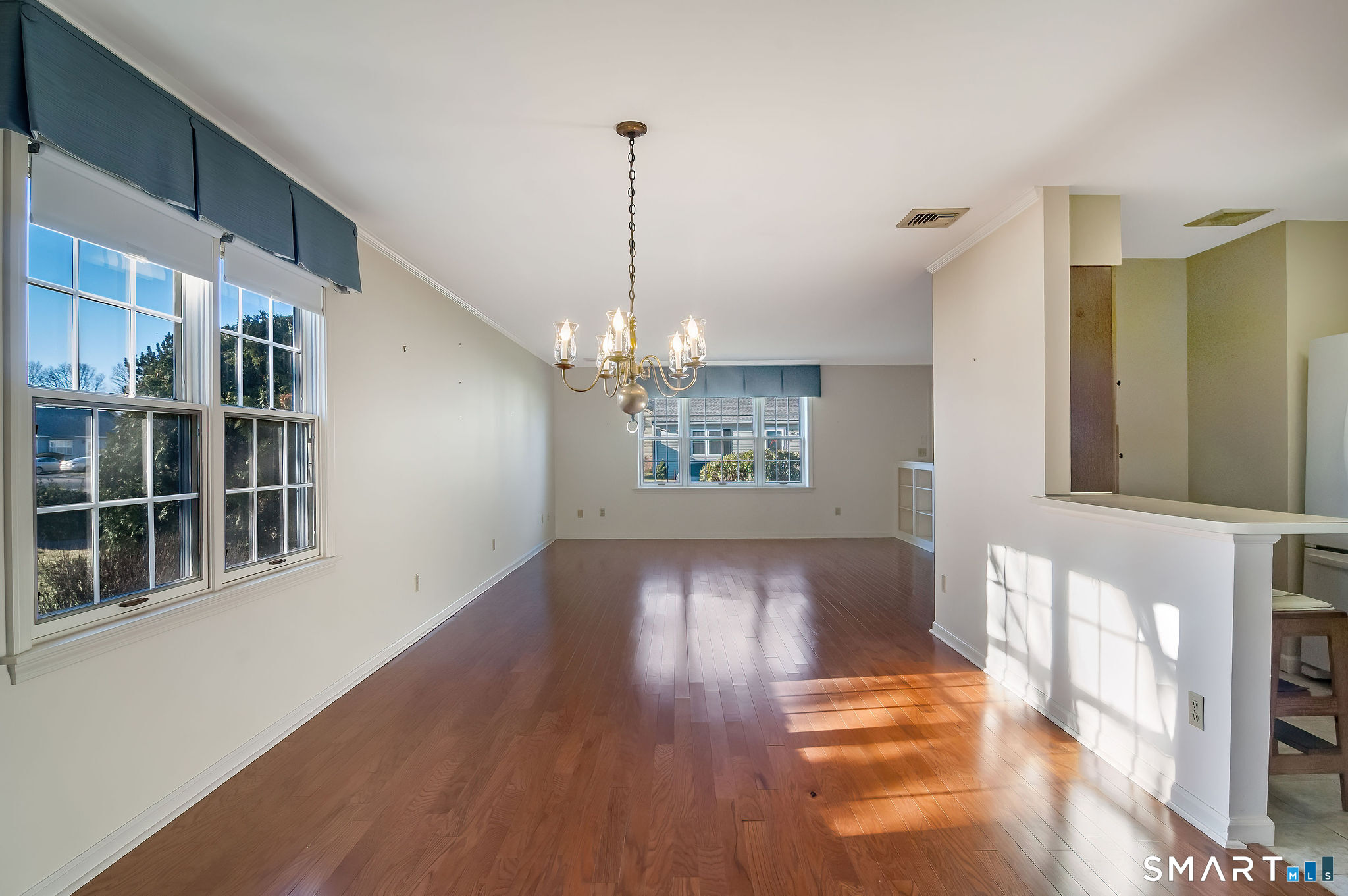 1 Downing Way, Unit 1 Madison, CT 06443 - Photo 9 of 26 a view of an empty room with wooden floor and a window