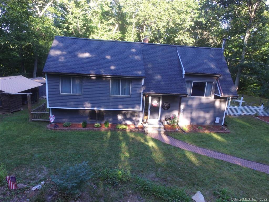 a view of house with a yard