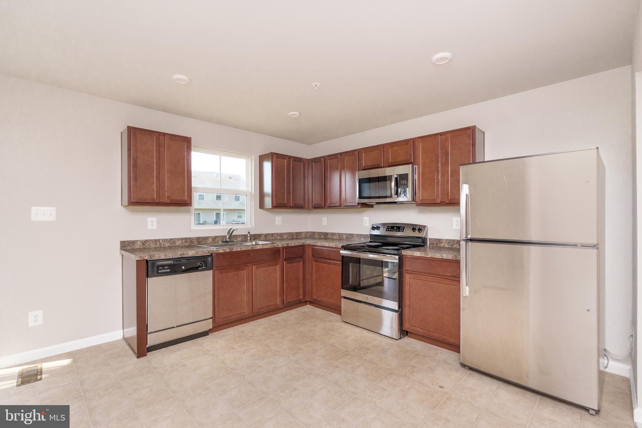 4 Marsh Lane Elkton, MD 21921 - Photo 3 of 14 a kitchen with stainless steel appliances granite countertop a refrigerator stove a sink dishwasher and a refrigerator