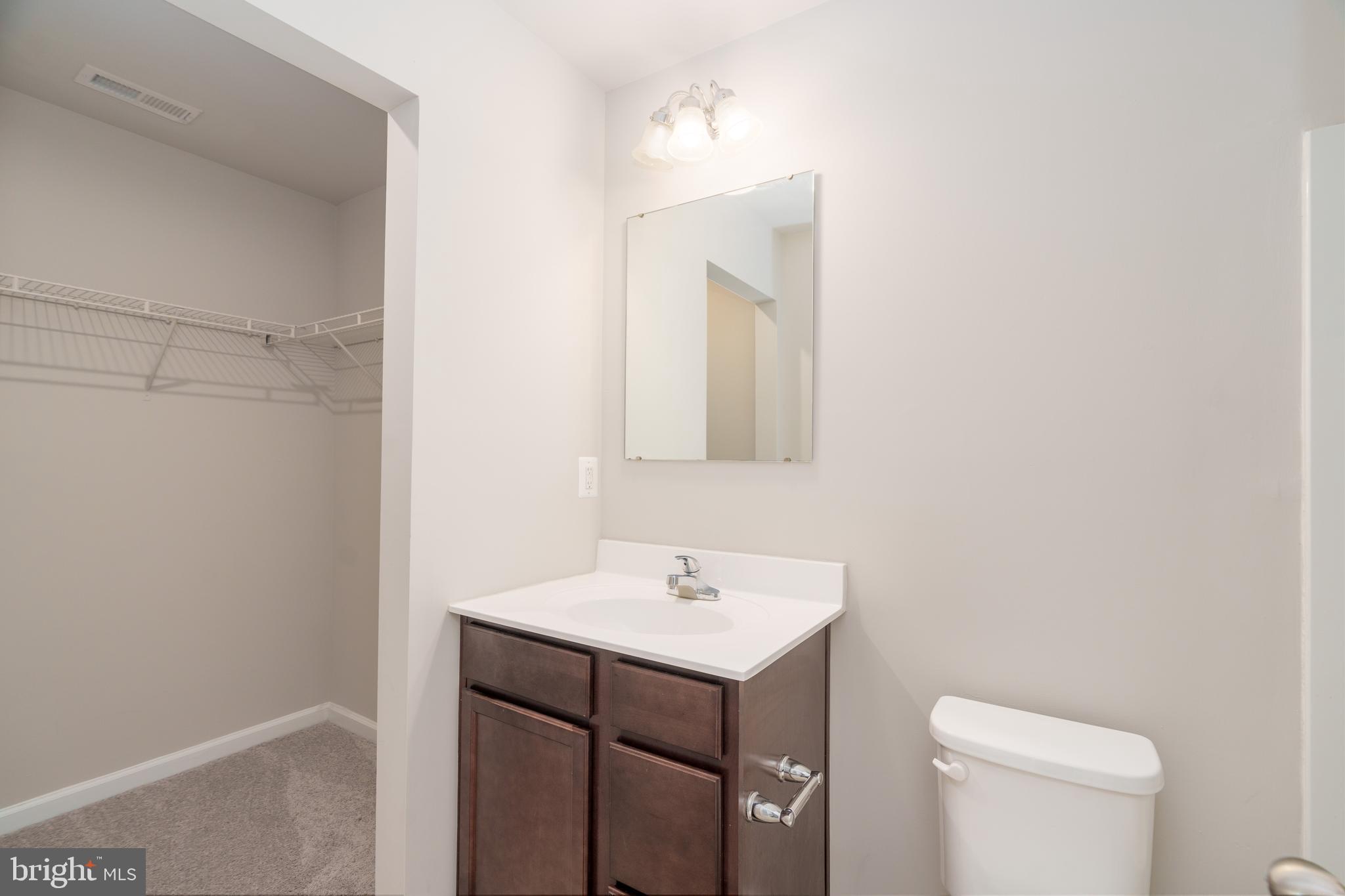 4 Marsh Lane Elkton, MD 21921 - Photo 7 of 14 a bathroom with a sink a toilet and a mirror
