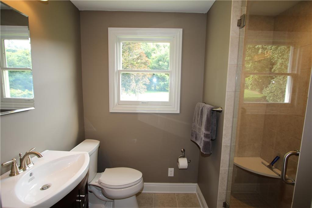 8 Momeyer Road Monongahela, PA 15063 - Photo 18 of 25 GORGEOUS Remodeled Bathroom on 2nd Level w/ Ceramic Tile Shower Stall, Shower Seat & Glass Door. Newer Ceramic Tile Flooring, Vanity & Comfy Height Toilet