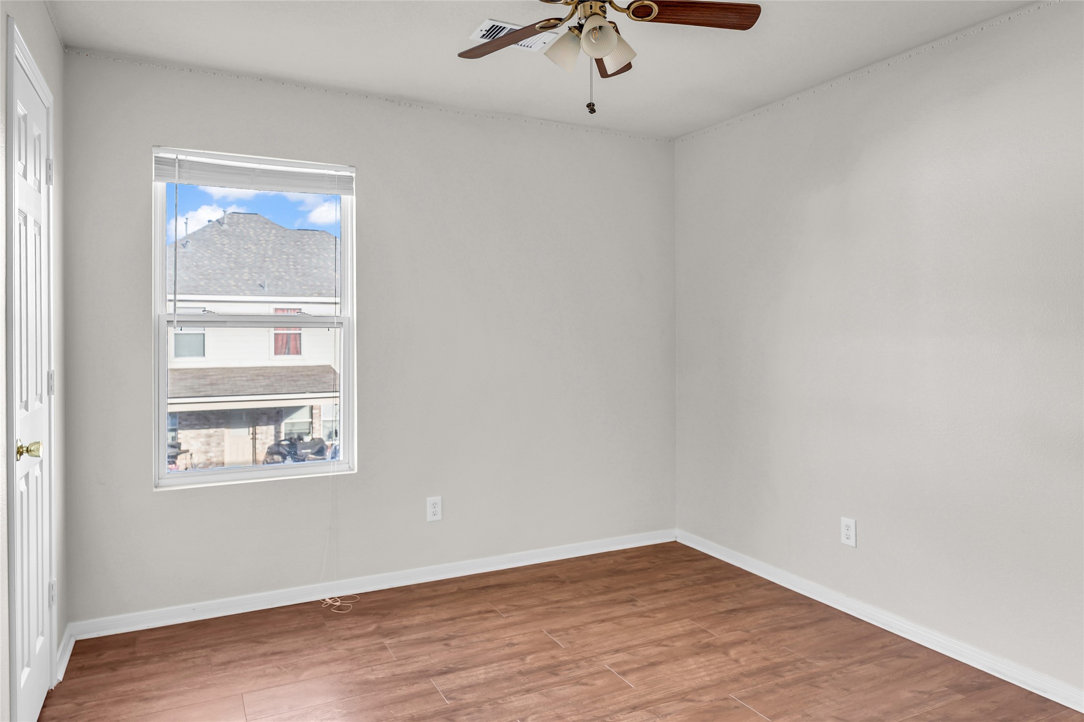 5018 Mabry Stream Court Katy, TX 77449 - Photo 22 of 31 This room features neutral walls, a window with natural light, and a ceiling fan with lights, creating a bright and versatile space.