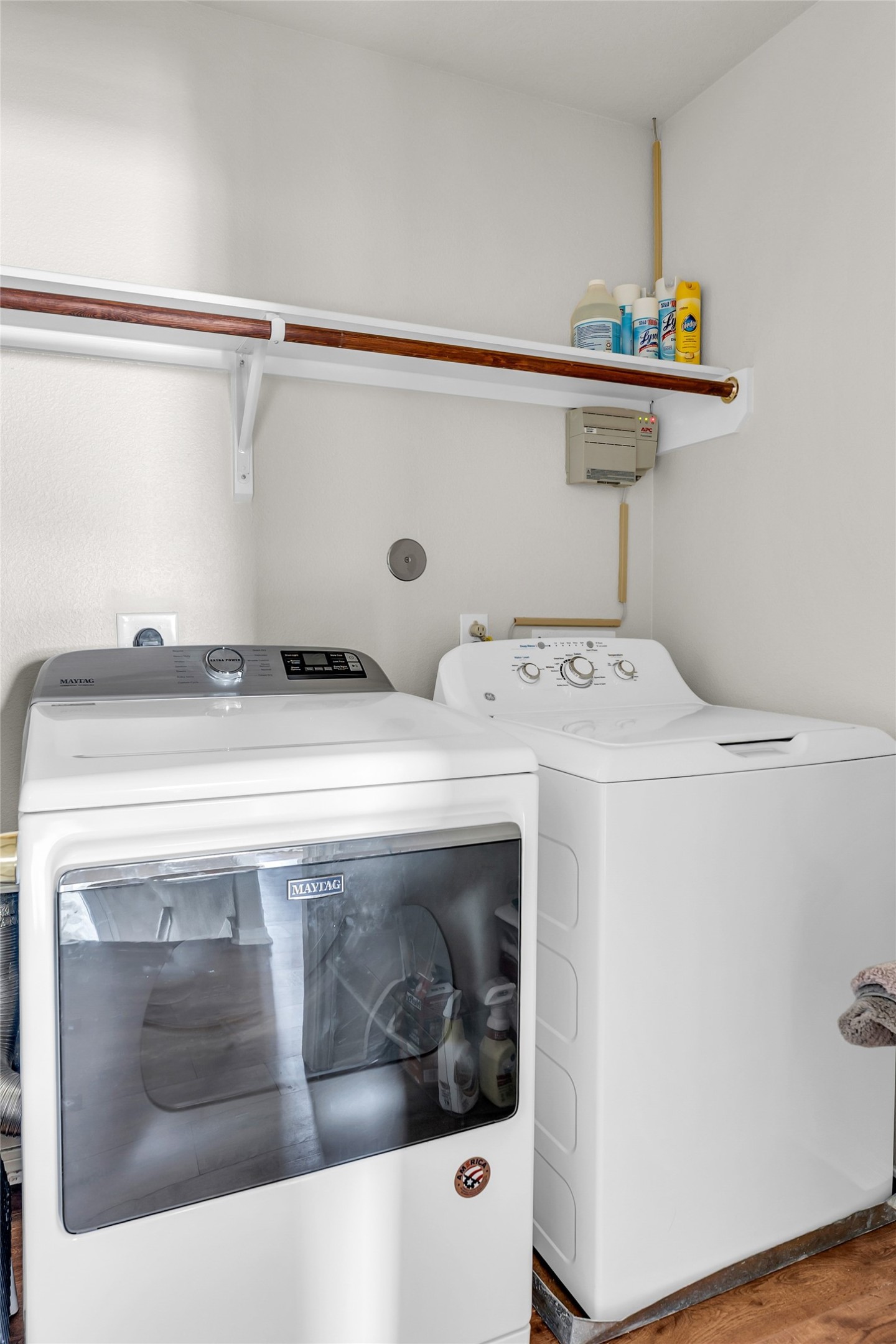 5018 Mabry Stream Court Katy, TX 77449 - Photo 30 of 31 This photo features laundry area with a washing machine and dryer. There's a shelf above for storage, holding various cleaning supplies. Providing functionality and convenience for household chores.