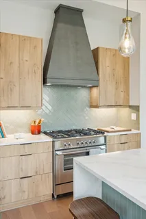 a kitchen with a stove and cabinets