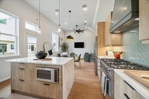 a kitchen that has a stove and a table