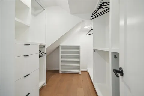 a view of closet area with stairs