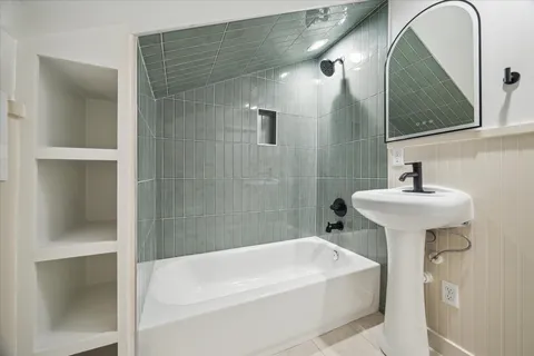 a white bath tub sitting next to a white sink