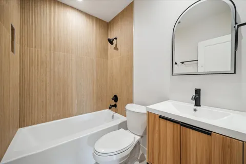 a bathroom with a sink a toilet and shower curtain