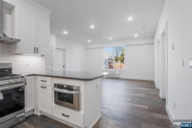 a kitchen with a stove top oven and a refrigerator