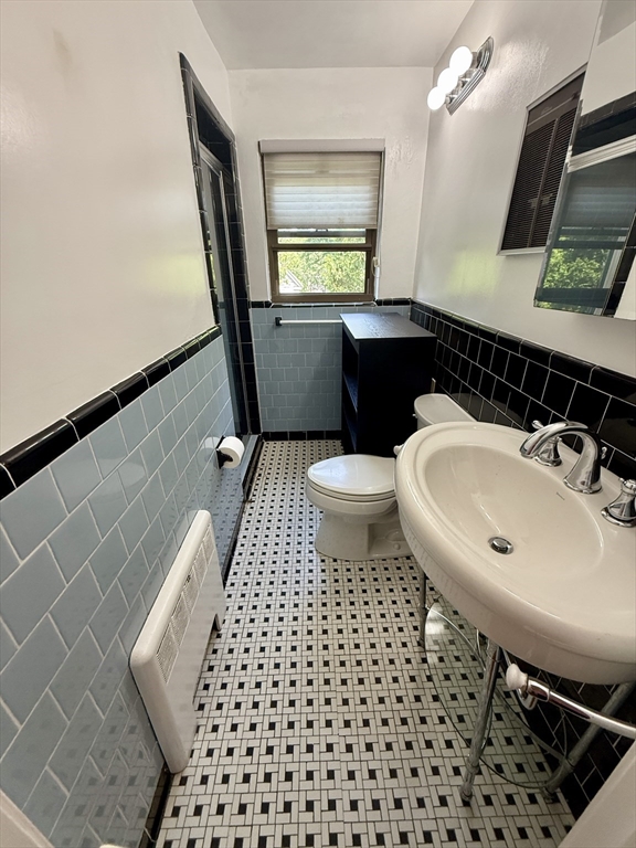 9 Reservoir Road, Unit 1 Brookline, MA 02467 - Photo 15 of 16 a bathroom with a sink and a mirror