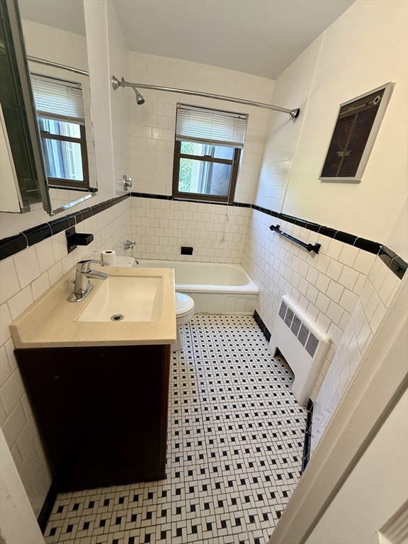 9 Reservoir Road, Unit 1 Brookline, MA 02467 - Photo 16 of 16 a bathroom with a sink and a mirror