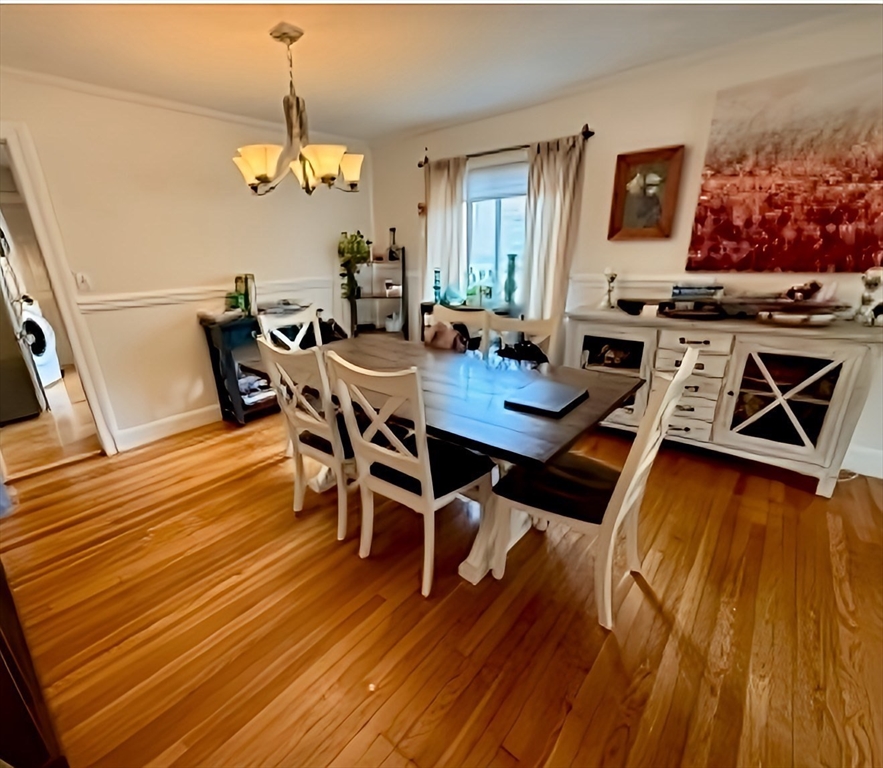 9 Reservoir Road, Unit 1 Brookline, MA 02467 - Photo 3 of 16 a view of a dining room with furniture and wooden floor