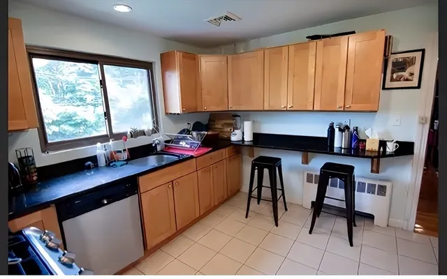a kitchen with a sink cabinets and window