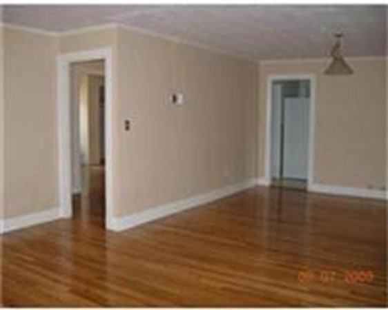 9 Reservoir Road, Unit 1 Brookline, MA 02467 - Photo 8 of 16 a view of a room with wooden floor and closet