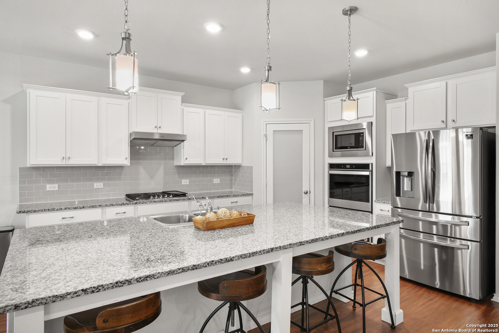 6908 Opus Lane Converse, TX 78109 - Photo 15 of 41 a kitchen with stainless steel appliances granite countertop a sink refrigerator and cabinets
