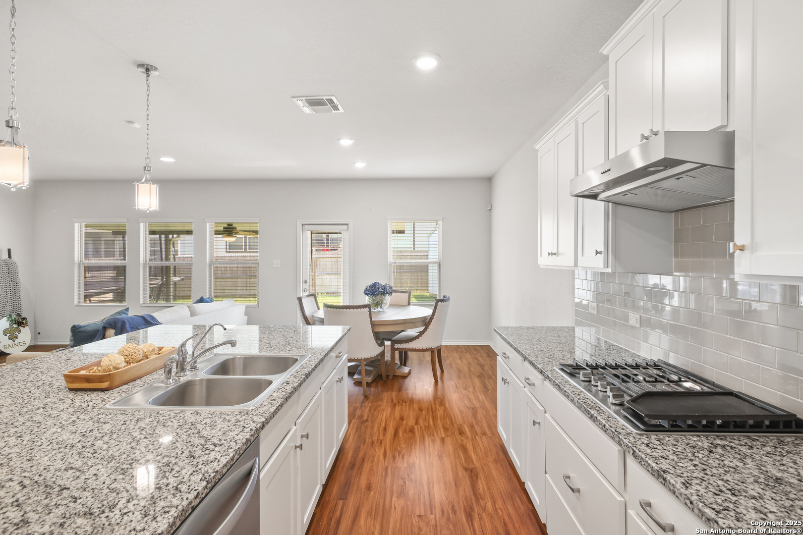 6908 Opus Lane Converse, TX 78109 - Photo 19 of 41 a kitchen with kitchen island granite countertop a sink and stove