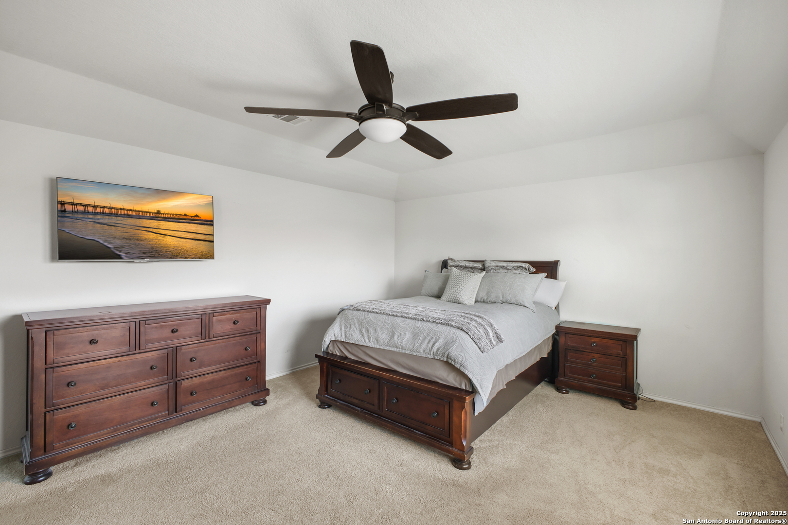 6908 Opus Lane Converse, TX 78109 - Photo 25 of 41 a spacious bedroom with a bed and a dresser