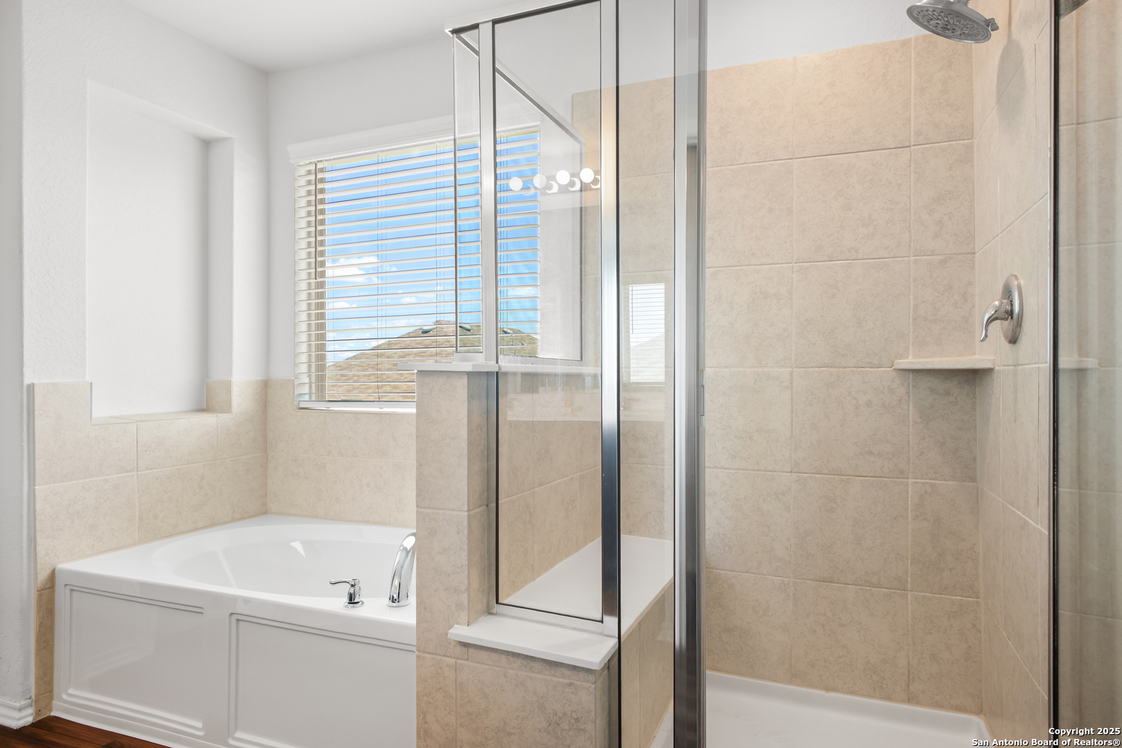 6908 Opus Lane Converse, TX 78109 - Photo 28 of 41 a bathroom with a tub a sink and a window