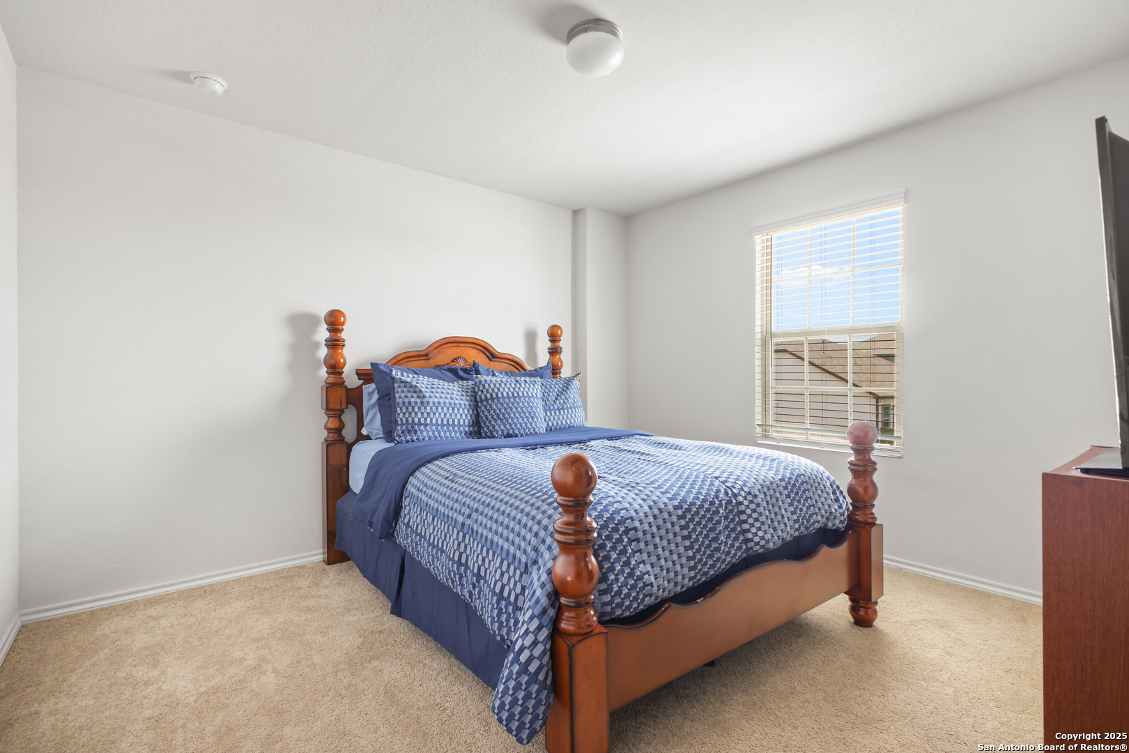 6908 Opus Lane Converse, TX 78109 - Photo 29 of 41 a bedroom with a bed and dresser