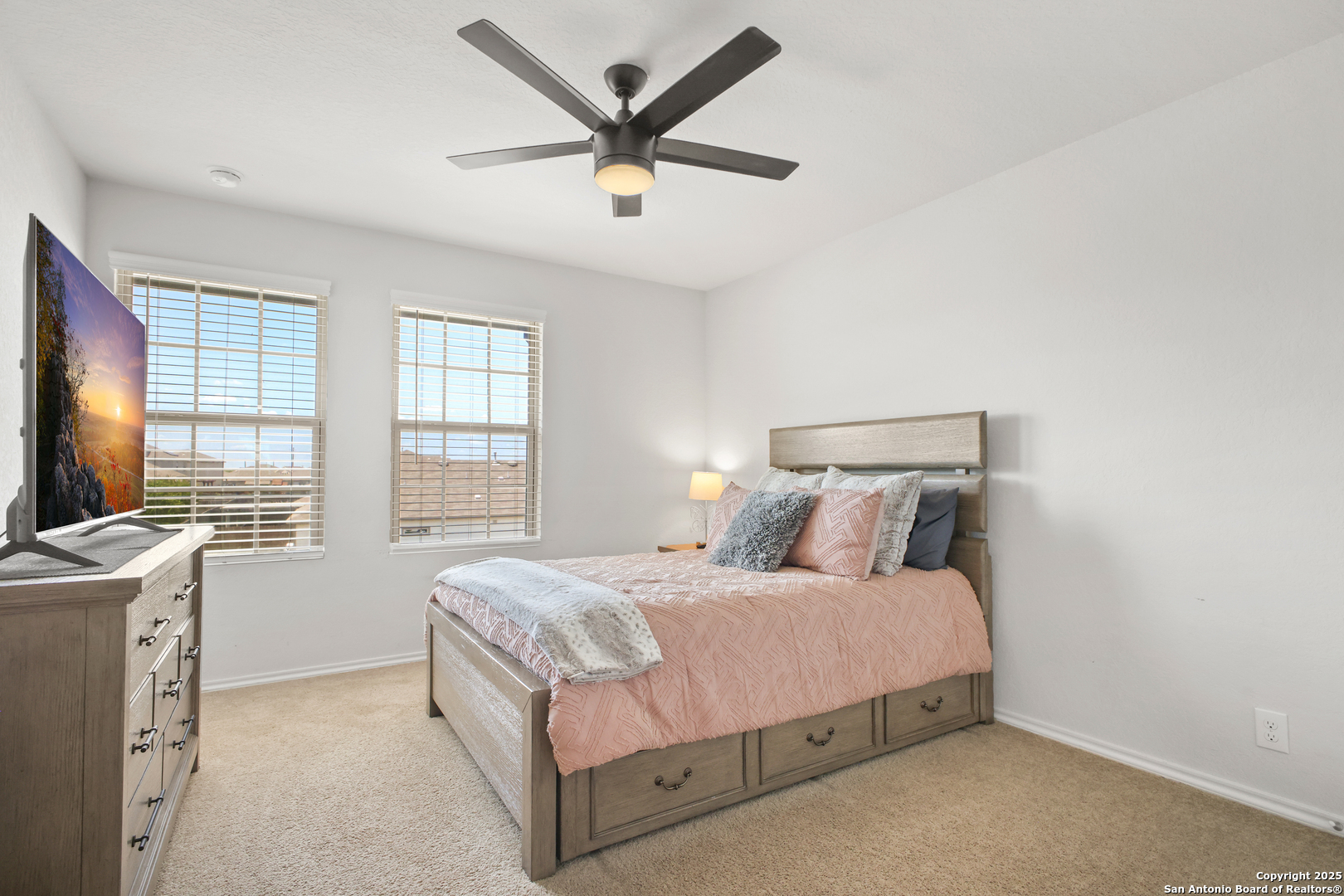 6908 Opus Lane Converse, TX 78109 - Photo 31 of 41 a bedroom with a bed a window and a flat screen tv
