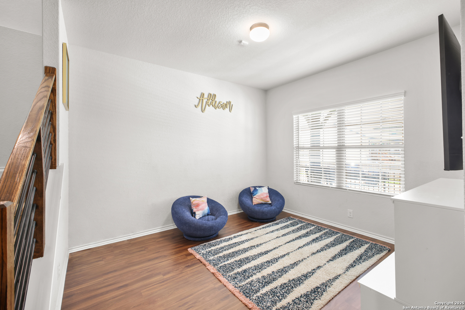 6908 Opus Lane Converse, TX 78109 - Photo 8 of 41 a view of an empty room with wooden floor and a window