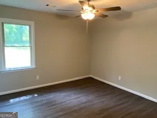 a view of a room with wooden floor and windows