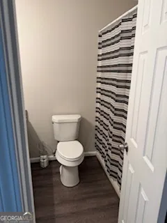 a white toilet sitting next to a sink