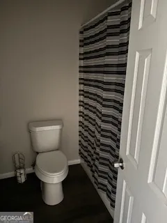 a white toilet sitting next to a sink