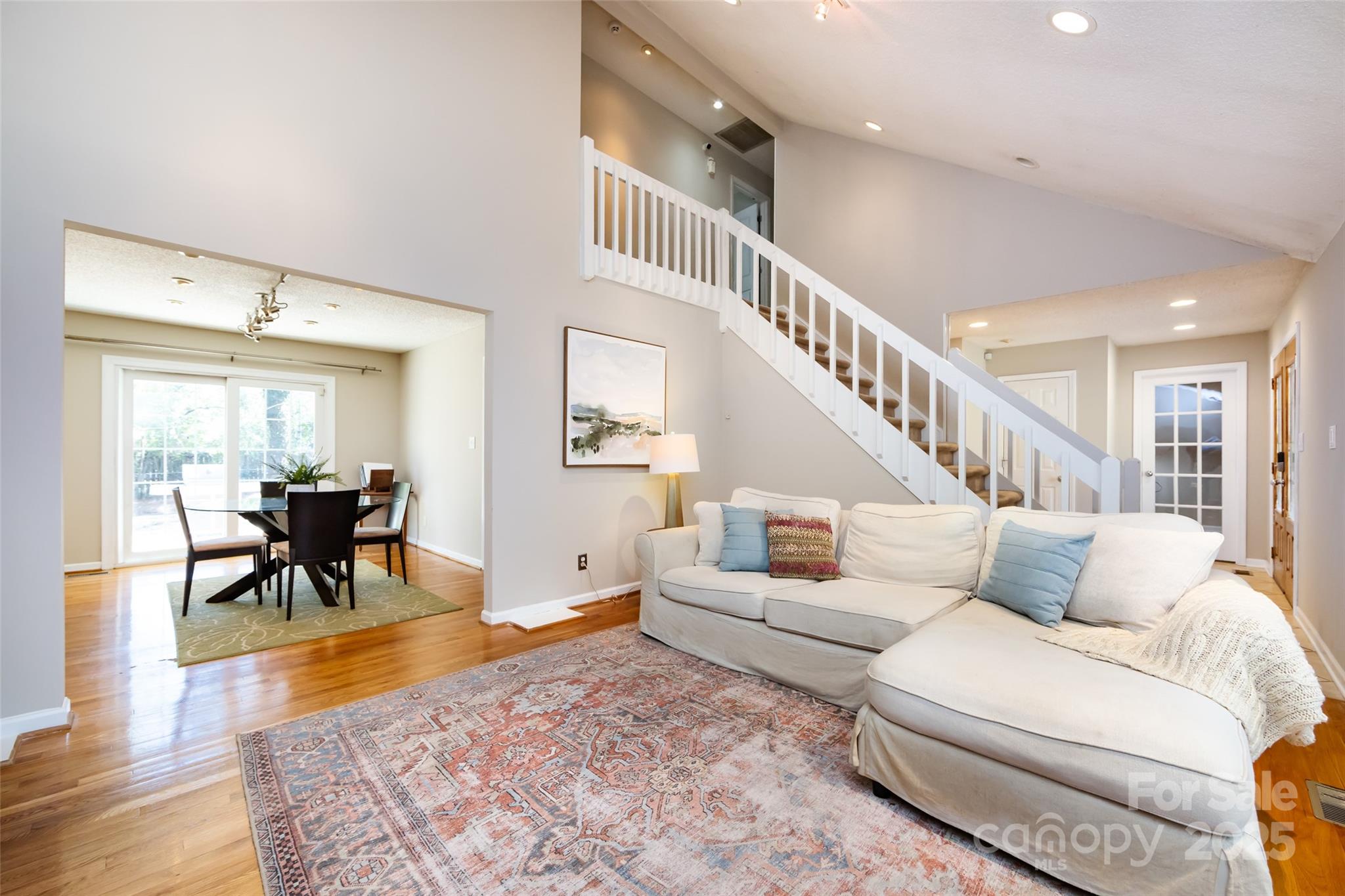 5013 Cedar Forest Drive Charlotte, NC 28226 - Photo 17 of 46 a living room with furniture and a dining table with wooden floor