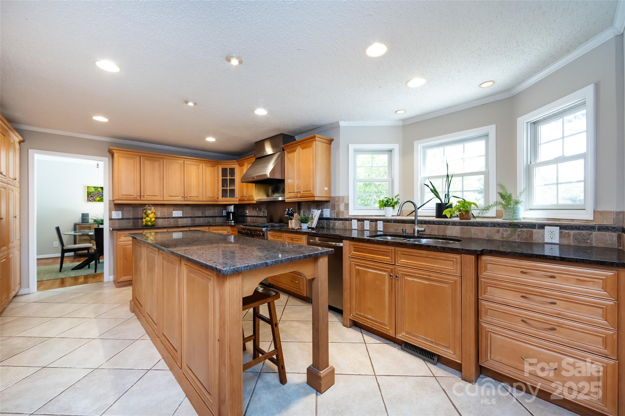 5013 Cedar Forest Drive Charlotte, NC 28226 - Photo 20 of 46 a kitchen with granite countertop a sink and cabinets