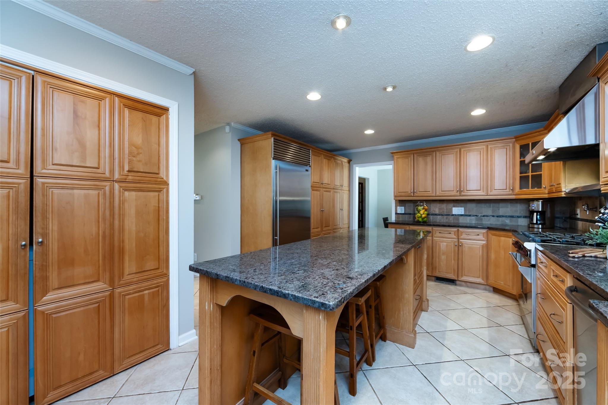 5013 Cedar Forest Drive Charlotte, NC 28226 - Photo 23 of 46 a kitchen with granite countertop stainless steel appliances a refrigerator and wooden cabinets