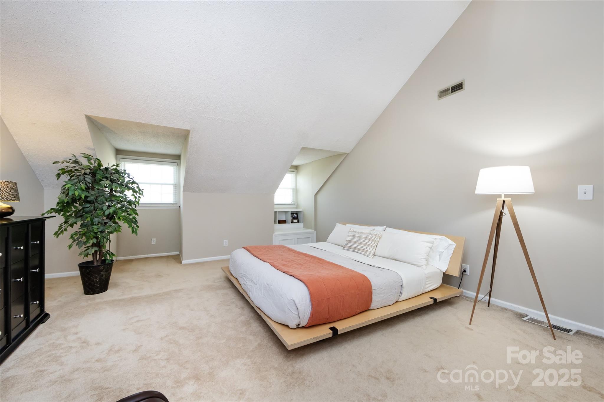 5013 Cedar Forest Drive Charlotte, NC 28226 - Photo 31 of 46 a bedroom with a bed and a potted plant