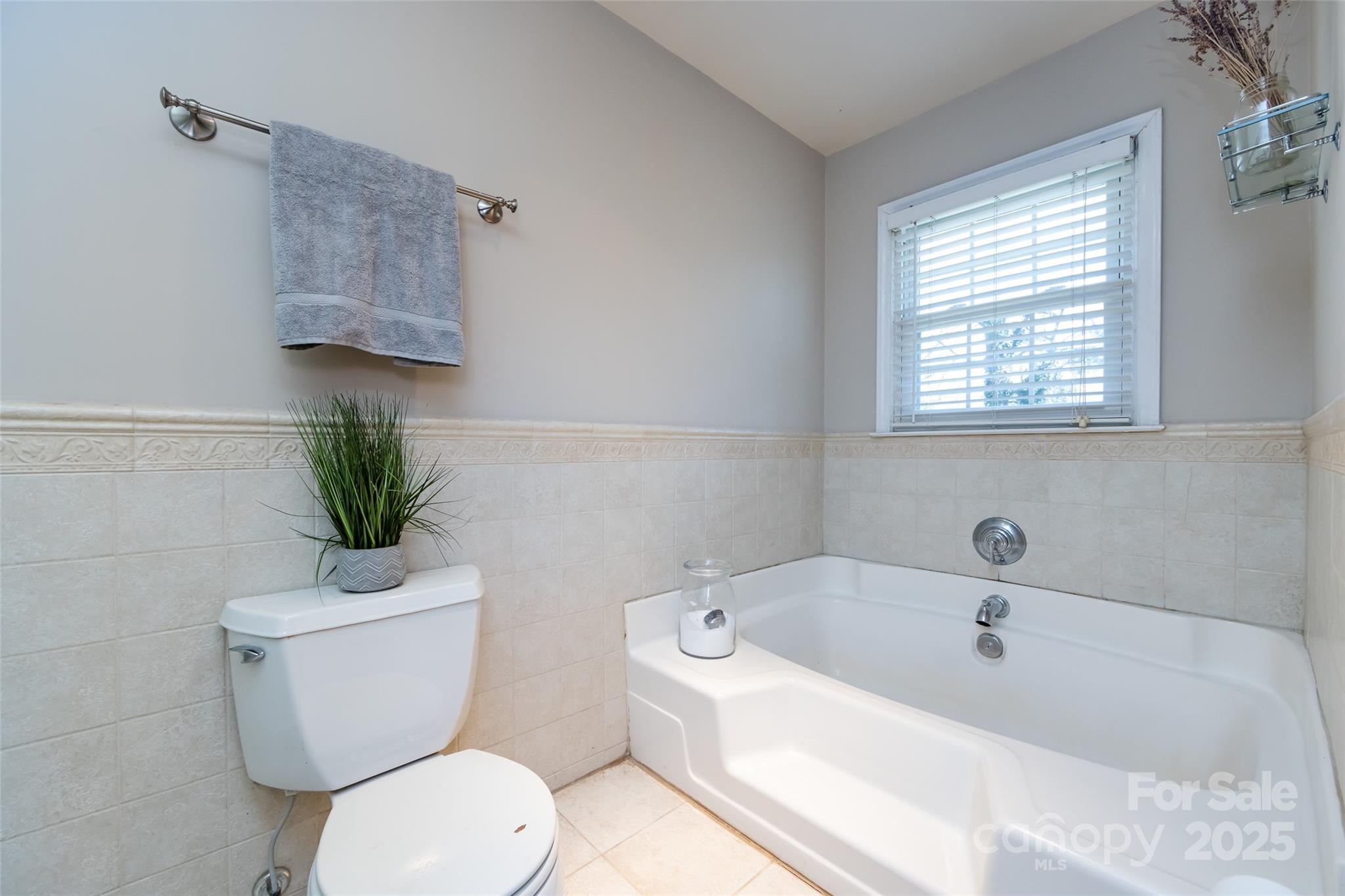 5013 Cedar Forest Drive Charlotte, NC 28226 - Photo 33 of 46 a white toilet sitting next to a bath tub