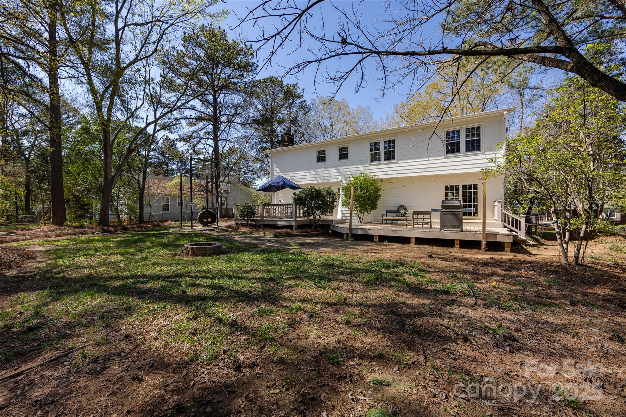 5013 Cedar Forest Drive Charlotte, NC 28226 - Photo 46 of 46 a view of a white house next to a yard with big trees