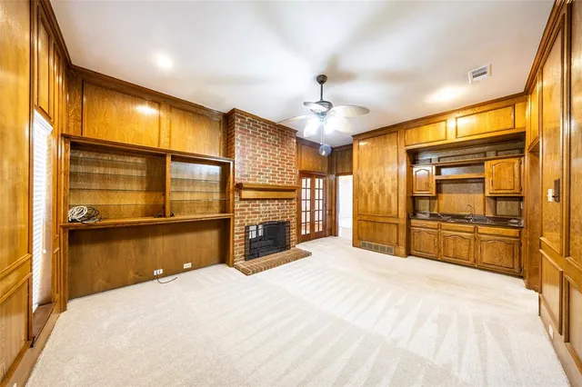 a large bedroom with a large bed and chandelier