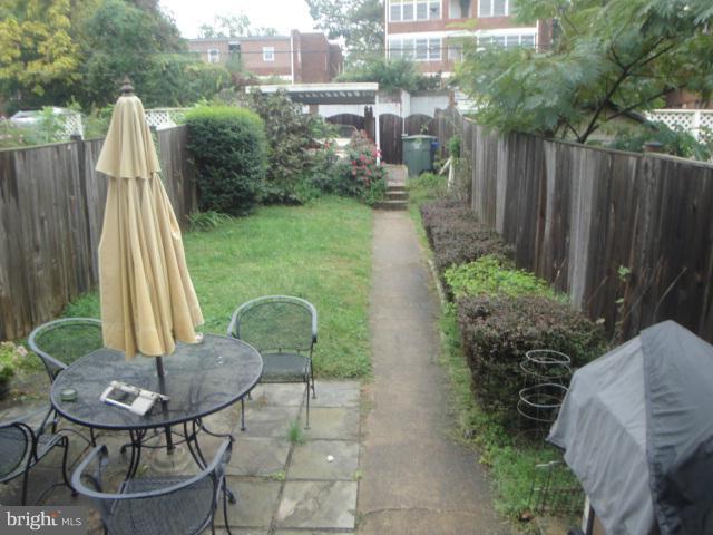 1334 Rittenhouse Street Northwest Washington, DC 20011 - Photo 14 of 14 a backyard of a house with table and chairs