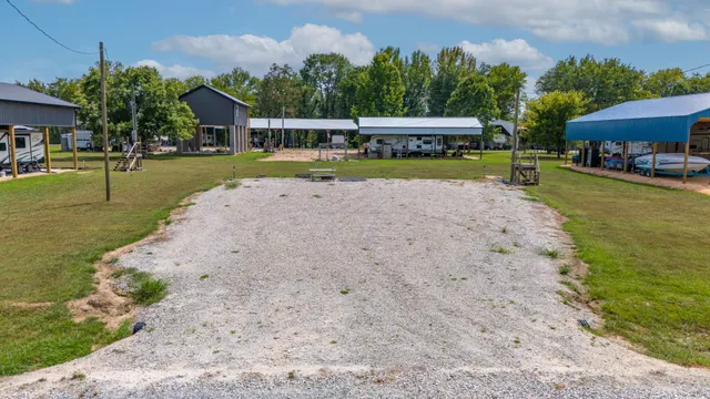 a view of a swimming pool with lawn chairs under an umbrella