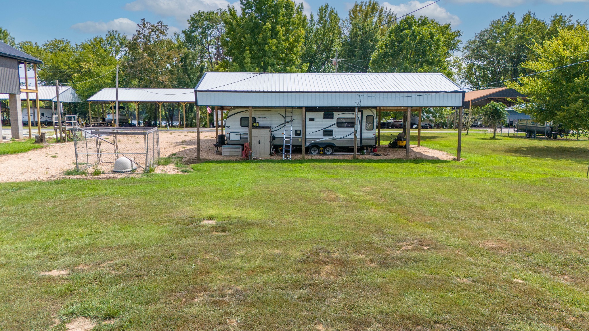 1020 WC PICKETT Road Clifton, TN 38425 - Photo 12 of 25 a view of a swimming pool with lawn chairs under an umbrella