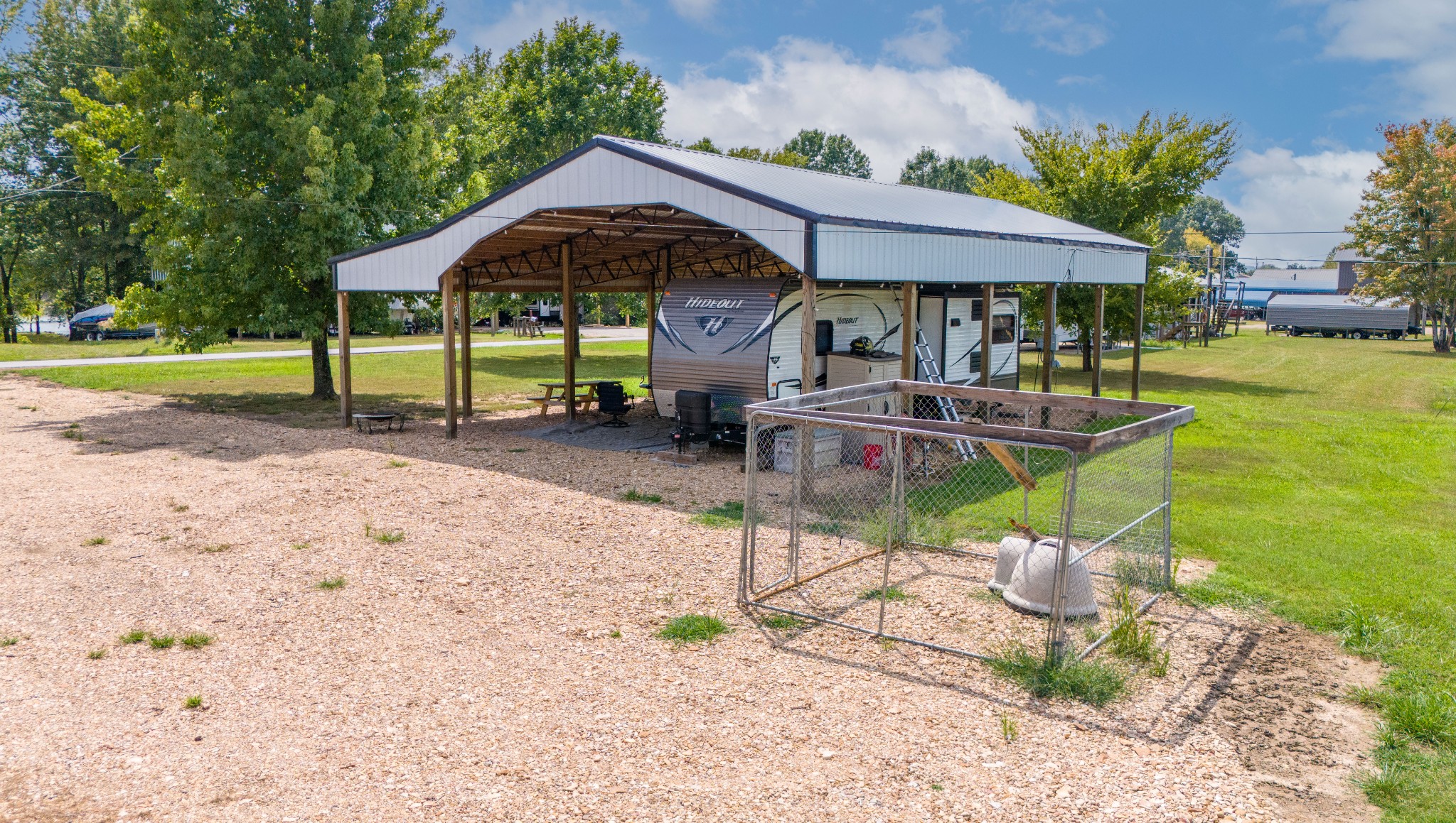 1020 WC PICKETT Road Clifton, TN 38425 - Photo 13 of 25 a patio with a table and chairs under an umbrella