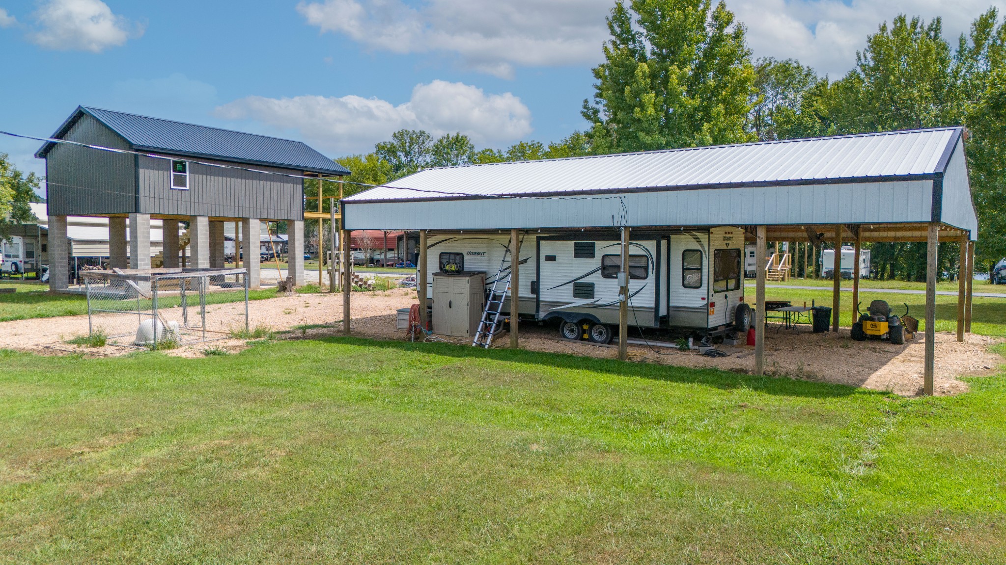 1020 WC PICKETT Road Clifton, TN 38425 - Photo 19 of 25 a view of a patio with table and chairs under an umbrella