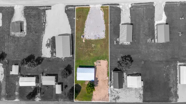 an aerial view of residential house with outdoor space and parking