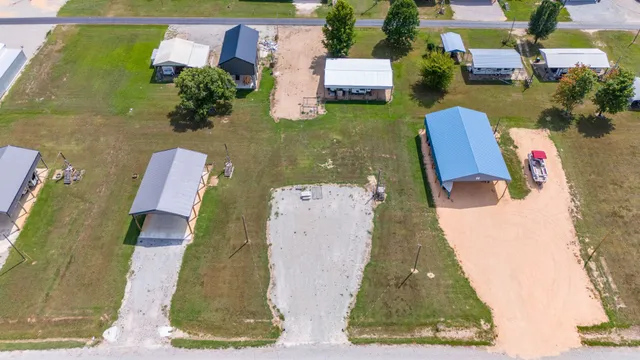 an aerial view of lake residential houses with outdoor space and lake view in back