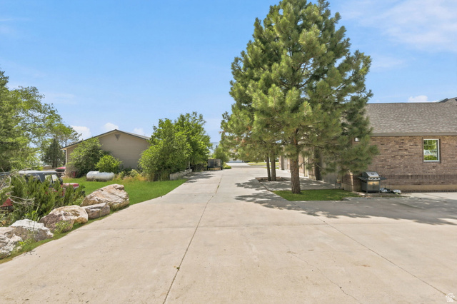 580 North 300 East Logan, UT 84321 - Photo 60 of 74 Concrete driveway with natural rock landscaping